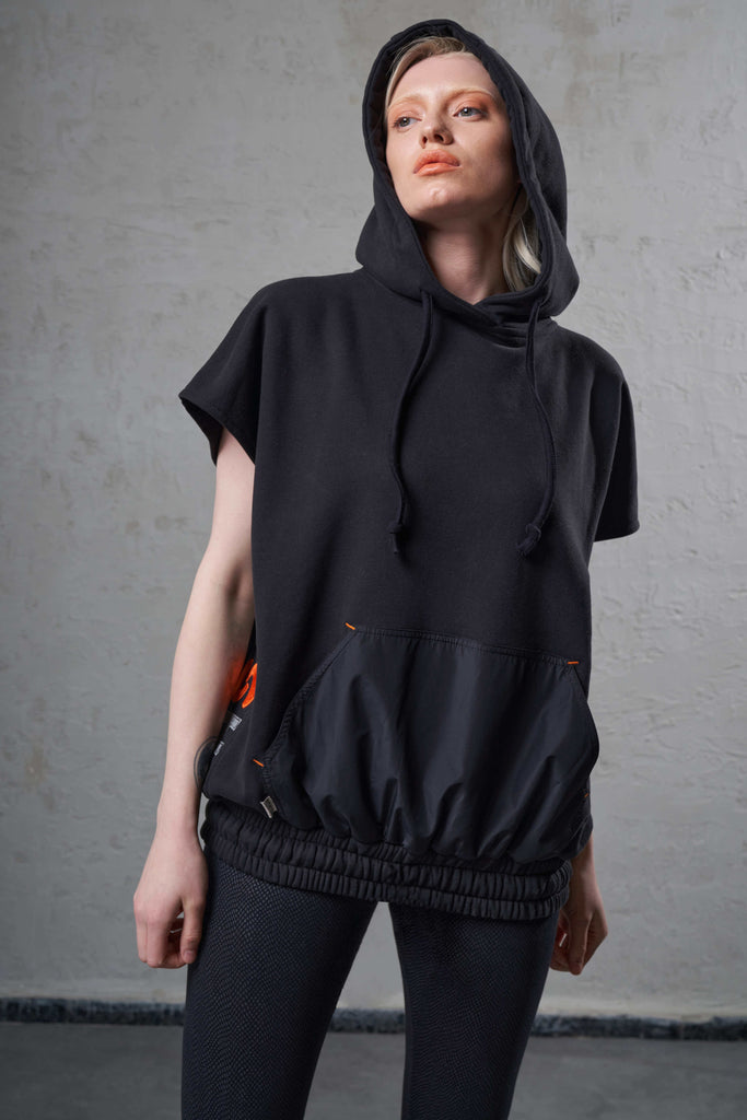 woman wearing sleeveless black eco-friendly hoodie top 