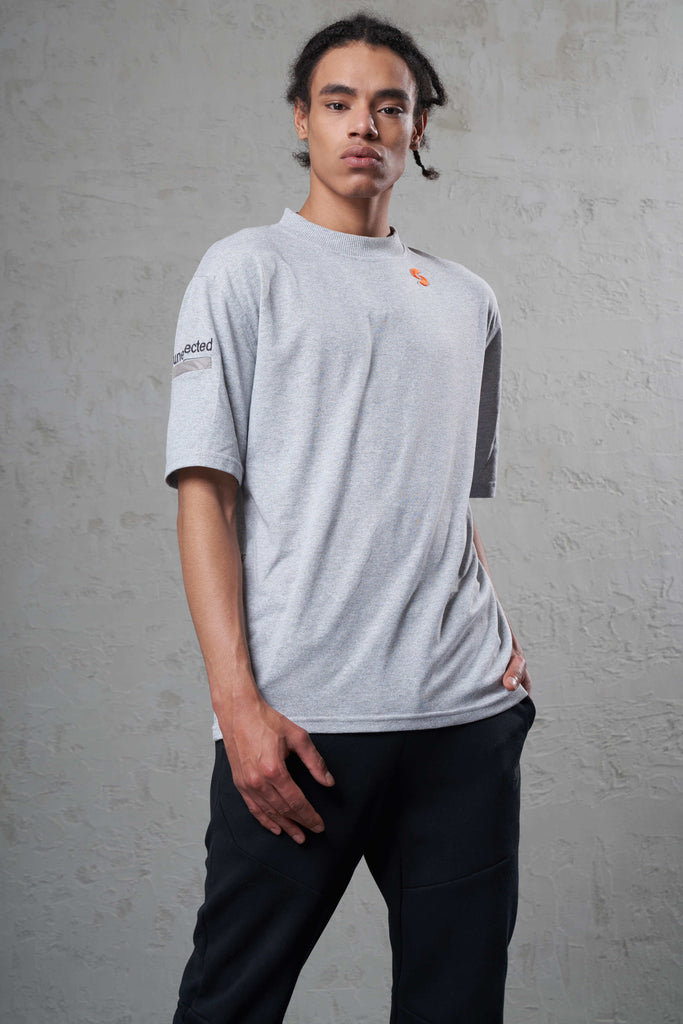 young man wearing a cool grey color t-shirt made with sustainable cotton 