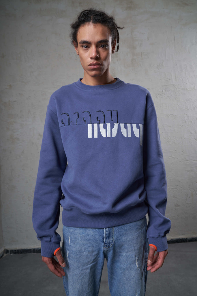 young man wearing a regular fit crew neck sweat with thumb holes