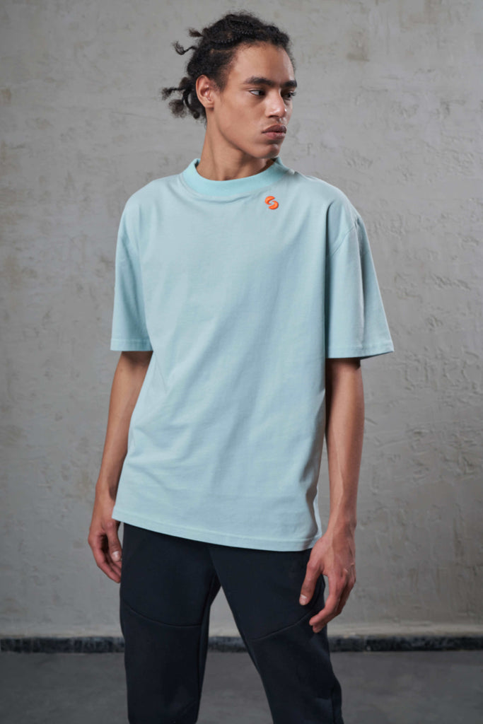 young man wearing a mint color sustainable cotton t-shirt with embroidery
