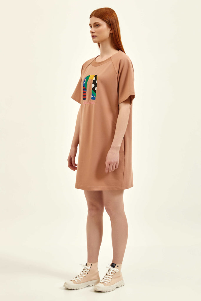 side look of a light brown short dress with an embroidery detail