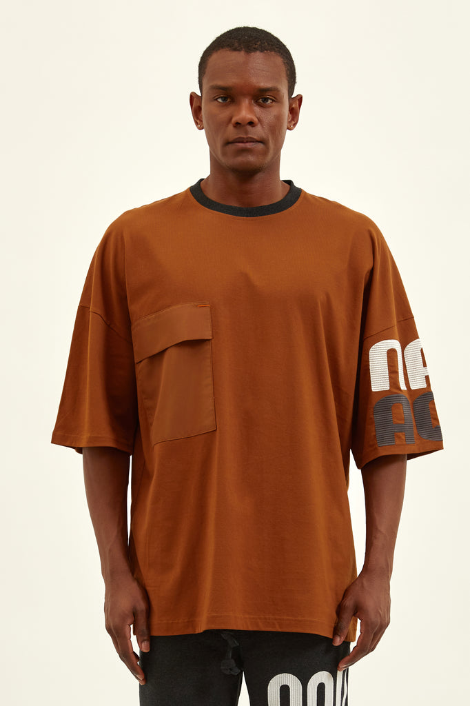 young black man wearing a candy brown sustainable oversize t-shirt